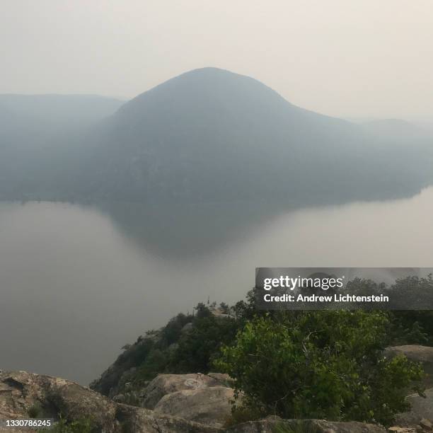 Smoke from forest fires 3,000 miles on the West Coast creates a haze over the Hudson River, obscuring the view of Storm King Mountain, on July 20 in...