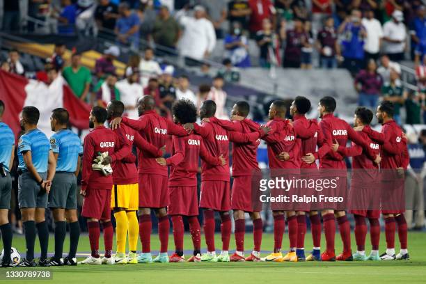 The Qatar soccer team join together during the playing of the country's national anthem prior to the Concacaf Gold Cup quarterfinal match between...