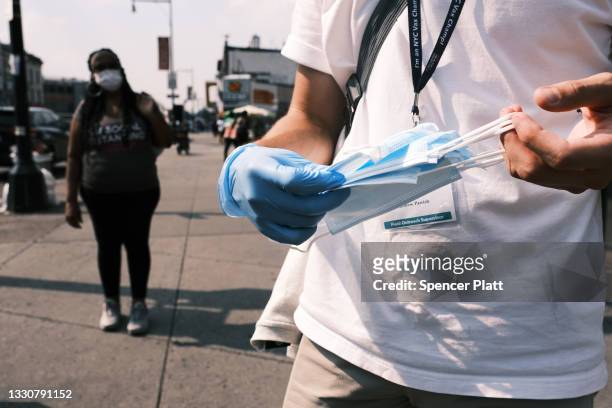 Members of the Test and Trace Corps walk the streets of Brooklyn passing out masks and trying to sign people up for the COVID-19 vaccine on July 26,...