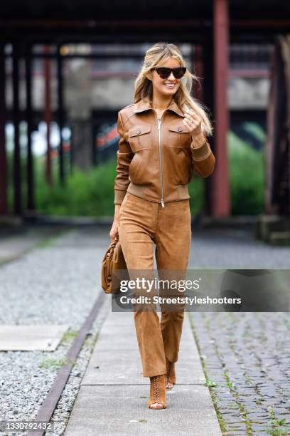 Influencer Gitta Banko wearing a monochrome look, cognac colored leather jacket by Jitrois, cognac colored suede pants by Arma, cognac colored suede...