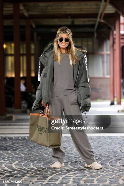 Influencer Gitta Banko wearing a olive green sweater by Iris von Arnim, olive green sweatpants by Iris von Arnim, a olive green jacket by Khrisjoy,...