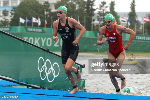 Nicole van der Kaay of Team New Zealand and Nicola Spirig of Team Switzerland compete during the Women's Individual Triathlon on day four of the...