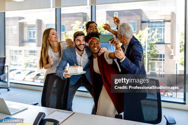 friendly multi-ethnic employees are celebrating birthday together and taking a selfie. - party board meets stock pictures, royalty-free photos & images