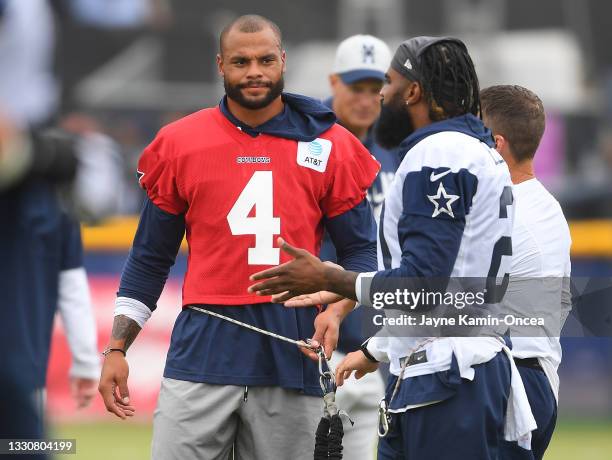 Running back Ezekiel Elliott and quarterback Dak Prescott of the Dallas Cowboys warm up before the start of training camp at River Ridge Complex on...