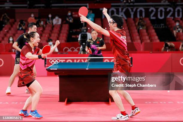 Mima Ito and Jun Mizutani of Team Japan react after winning their Mixed Doubles Gold Medal match on day three of the Tokyo 2020 Olympic Games at...