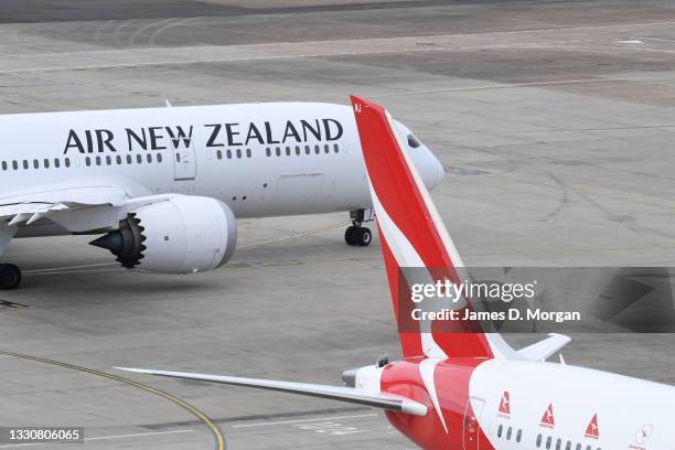 An Air New Zealand aircraft and an Qantas aircraft on the arrivals apron at Kingsford Smith International airport on July 26, 2021 in Sydney,...