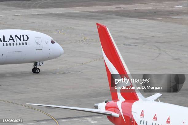 An Air New Zealand aircraft and an Qantas aircraft on the arrivals apron at Kingsford Smith International airport on July 26, 2021 in Sydney,...