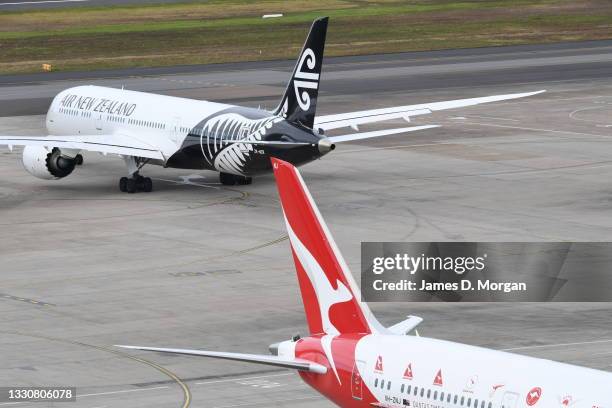 An Air New Zealand aircraft and an Qantas aircraft on the arrivals apron at Kingsford Smith International airport on July 26, 2021 in Sydney,...