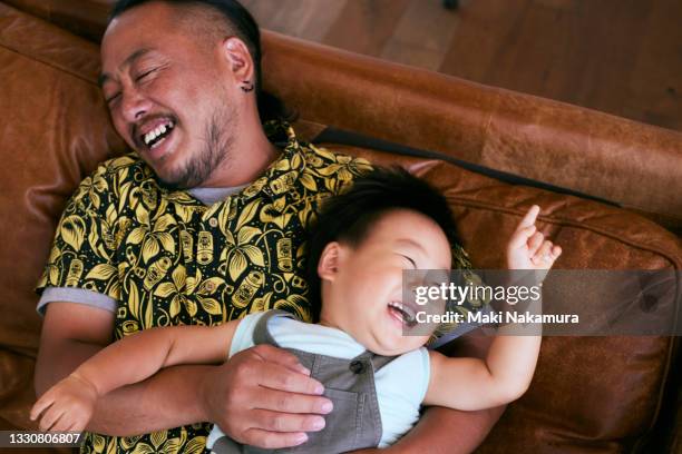 dad and boy are happy and laughable. - tears of joy stock-fotos und bilder