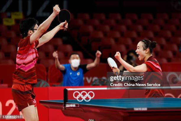 Jun Mizutani and Mima Ito of Japan celebrate after winning the Mixed Doubles Gold Medal Match against Xu Xin and Liu Shiwen of China on day three of...