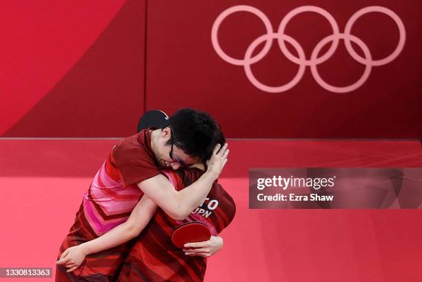 Ito Mima and Jun Mizutani of Team Japan celebrate winning during their Mixed Doubles Gold Medal match on day three of the Tokyo 2020 Olympic Games at...