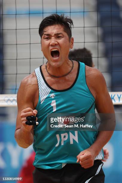 Yusuke Ishijima of Team Japan celebrates against Team Italy during the Men's Preliminary - Pool F beach volleyball on day four of the Tokyo 2020...