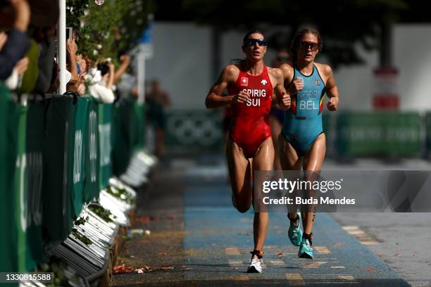 Nicola Spirig of Team Switzerland and Valerie Barthelemy of Team Belgium compete during the Women's Individual Triathlon on day four of the Tokyo...
