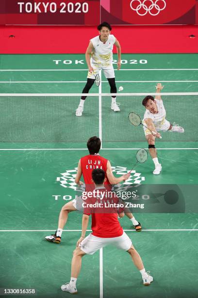 Takeshi Kamura and Keigo Sonoda of Team Japan compete against Li Jun Hui and Liu Yu Chen of Team China during a Men's Doubles Group C match on day...