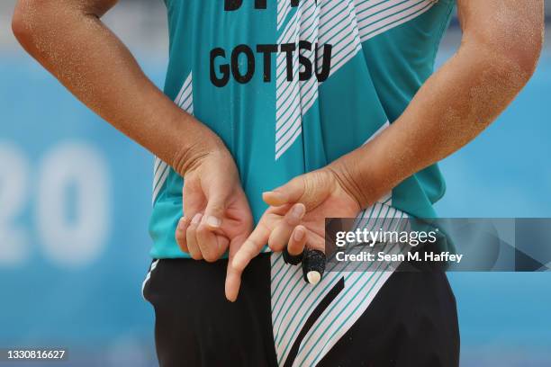 Yusuke Ishijima of Team Japan signals against Team Italy during the Men's Preliminary - Pool F beach volleyball on day four of the Tokyo 2020 Olympic...