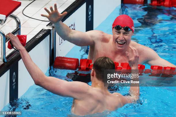 Tom Dean of Team Great Britain shakes hands with Duncan Scott of Team Great Britain after winning the gold medal in the Men's 200m Freestyle Final on...