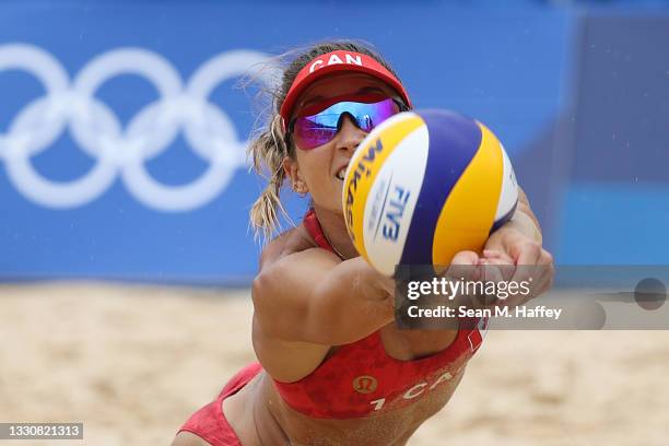 Heather Bansley of Team Canada dives to return the ball against Team Argentina during the Women's Preliminary - Pool C beach volleyball on day four...