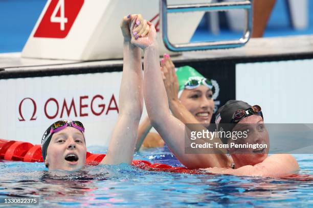 Lydia Jacoby of Team United States, Tatjana Schoenmaker of Team South Africa and Lilly King of Team United States celebrate after winning the gold,...