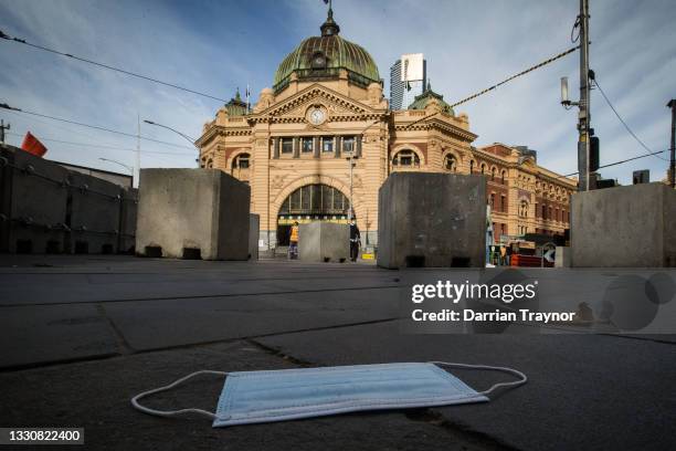 General view of the normally busy intersection of Flinders and Swanston streets outside Flinders Street station on July 27, 2021 in Melbourne,...