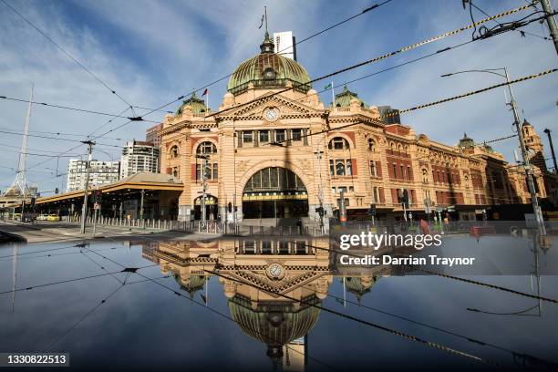 General view of the normally busy intersection of Flinders and Swanston streets outside Flinders Street station on July 27, 2021 in Melbourne,...