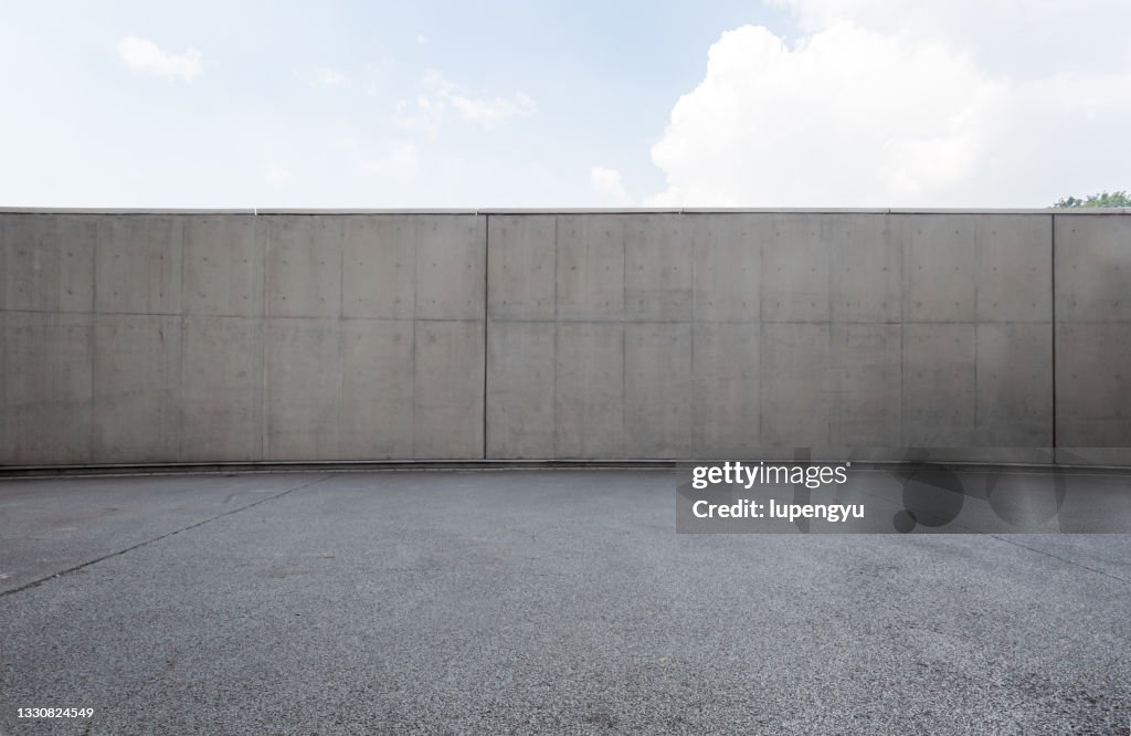 Empty parking lot and concrete wall