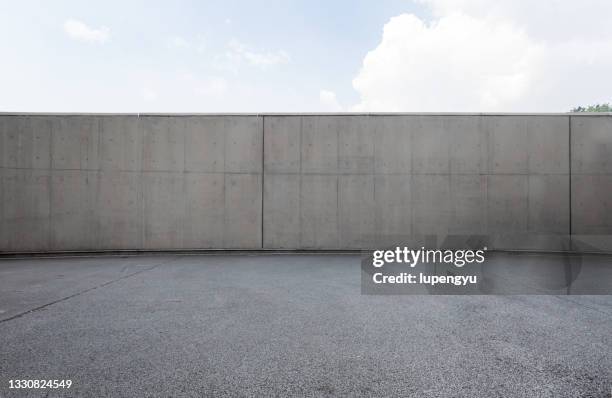 empty parking lot and concrete wall - mortar stock pictures, royalty-free photos & images