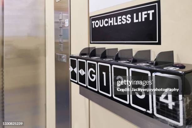 a touchless system in elevator for decrease infection from contact. - social distancing elevator stock pictures, royalty-free photos & images