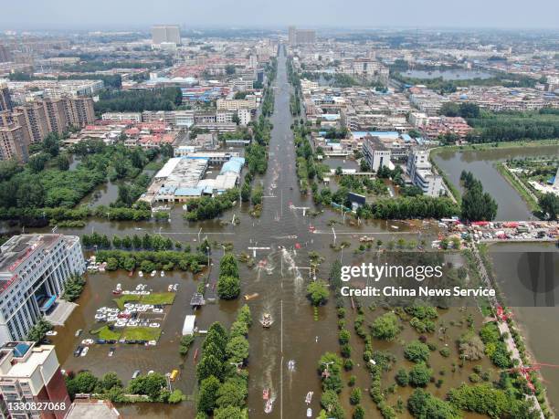 Aerial view of rescue team using inflatable rafts evacuate residents from flooded area after heavy downpour, on July 26, 2021 in Weihui, Xinjiang...