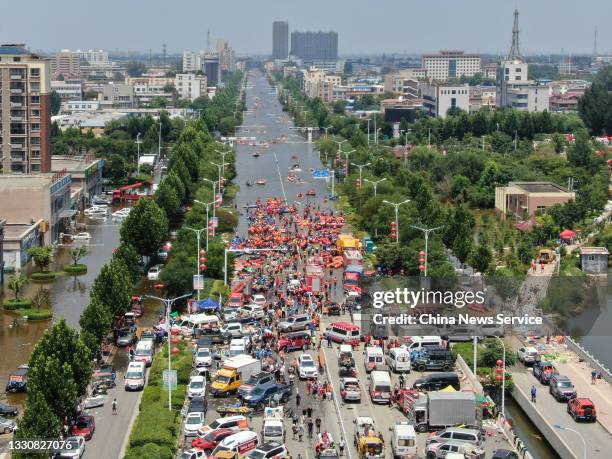 Aerial view of rescue team using inflatable rafts evacuate residents from flooded area after heavy downpour, on July 26, 2021 in Weihui, Xinjiang...