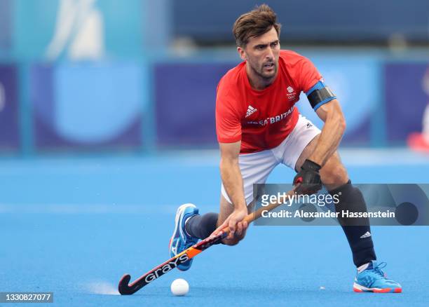 Adam Graham Dixon of Team Great Britain passes the ball during the Men's Preliminary Pool B match between Great Britain and Germany on day four of...