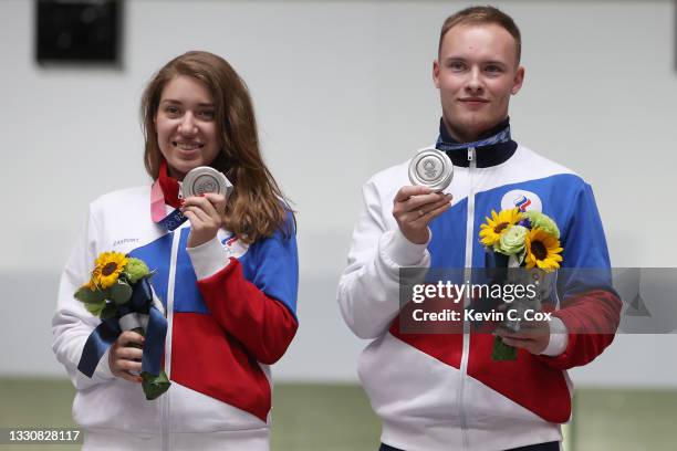 Silver Medalists Vitalina Batsarashkina and Artem Chernousov of Team ROC pose during the medal ceremony following the 10m Air Pistol Mixed Team event...