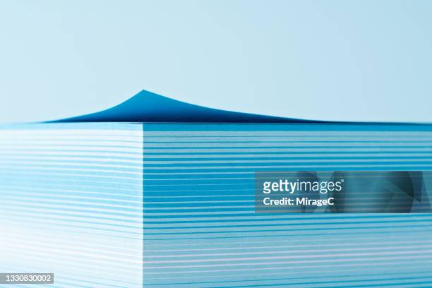 stacked blue paper with curved corner - thick stock pictures, royalty-free photos & images