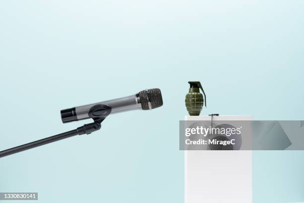 microphone to a grenade speech - handgranate stock-fotos und bilder