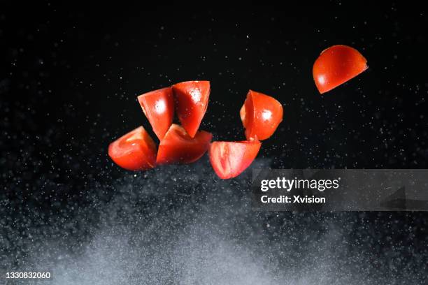 tomato slice flying in mid air captured with high speed sync"n - slow motion stock pictures, royalty-free photos & images