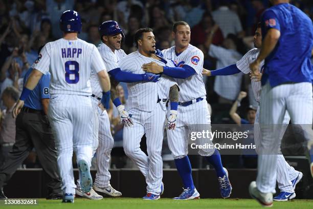 Javier Baez of the Chicago Cubs celebrates with teammates after his walk off single in the ninth inning against the Cincinnati Reds at Wrigley Field...