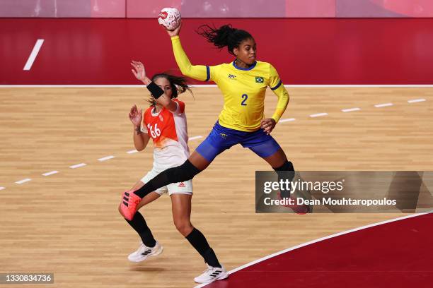 Bruna de Paula of Team Brazil shoots at goal as Viktoria Lukacs of Team Hungary looks on during the Woman's Preliminary Round Group B match between...