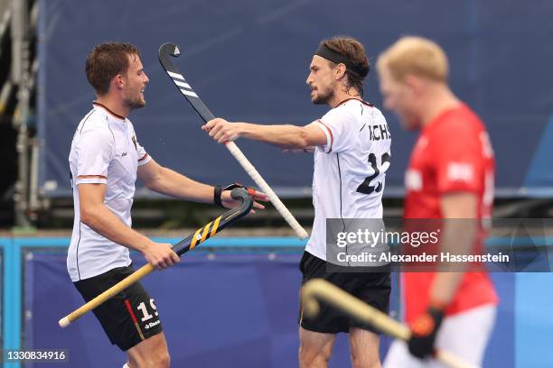 Florian Fuchs of Team Germany celebrates scoring the fourth goal with Justus Weigand during the Men's Preliminary Pool B match between Great Britain...