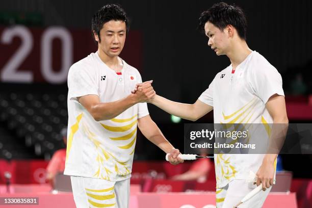 Hiroyuki Endo and Yuta Watanabe of Team Japan react as they win against Kim Astrup and Anders Skaarup Rasmussen of Team Denmark during a Men's...