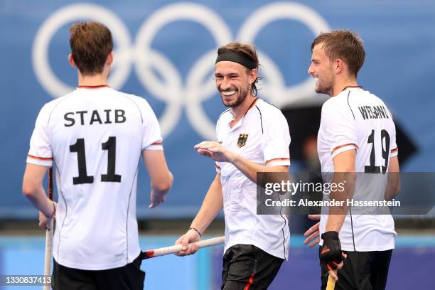Florian Fuchs of Team Germany scores the fifth goal and celebrates with teammates during the Men's Preliminary Pool B match between Great Britain and...