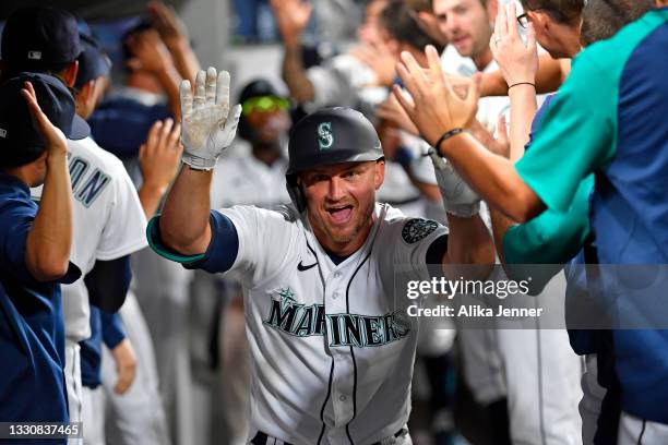Kyle Seager of the Seattle Mariners celebrates with teammates after hitting a three run home run in the fifth inning of the game against the Houston...