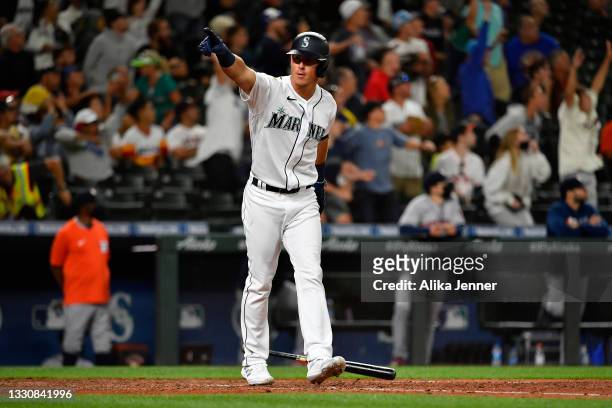 Dylan Moore of the Seattle Mariners gestures after hitting a grand slam home run in the eighth inning of the game against the Houston Astros at...