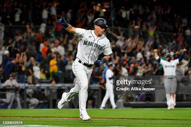 Dylan Moore of the Seattle Mariners gestures after hitting a grand slam home run in the eighth inning of the game against the Houston Astros at...