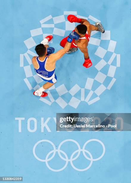 Ammar Riad Abduljabbar of Germany exchanges punches with Jose Maria Lucar Jaimes of Peru during the Men's Heavy on day four of the Tokyo 2020 Olympic...