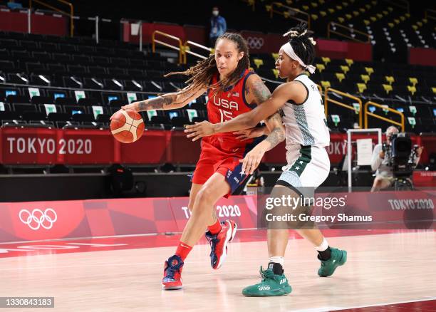 Brittney Griner of Team United States drives to the basket agasint Pallas Kunaiyi-Akpanah of Team Nigeria during the second half of a Women's...