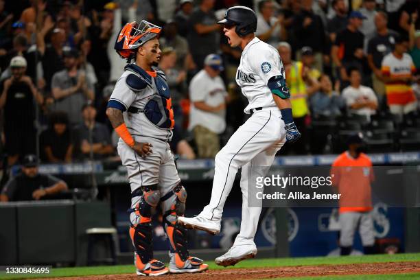 Dylan Moore of the Seattle Mariners celebrates after hitting a grand slam home run in the eighth inning of the game against the Houston Astros at...