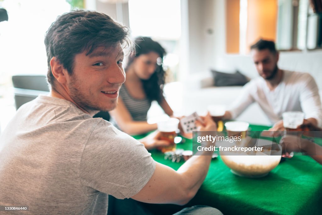Group of friends playing poker at home