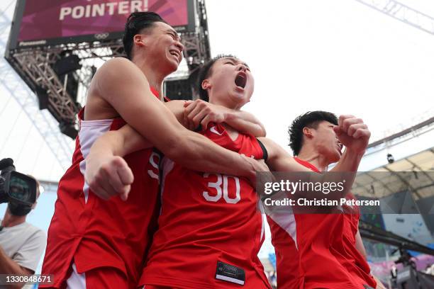 Tomoya Ochiai, Keisei Tominaga and Ryuto Yasuoka of Team Japan celebrate victory in the 3x3 Basketball competition on day four of the Tokyo 2020...