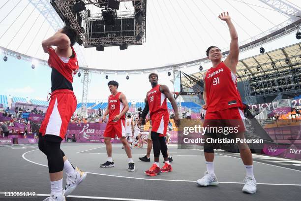 Tomoya Ochiai of Team Japan, Ira Brown of Team Japan and Ryuto Yasuoka of Team Japan celebrate victory in the 3x3 Basketball competition on day four...