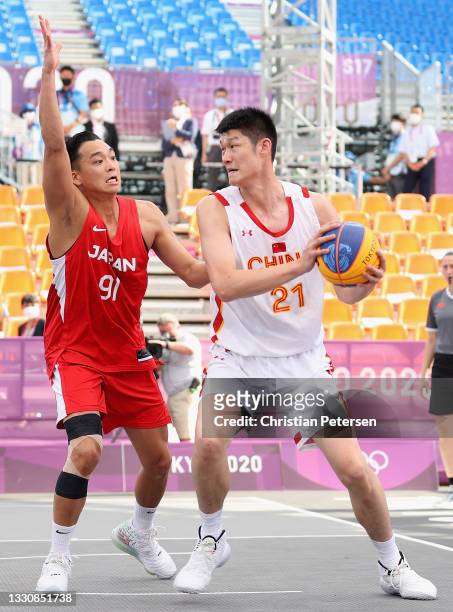 Jinqiu Hu of Team China handles the ball against Tomoya Ochiai of Team Japan in the 3x3 Basketball competition on day four of the Tokyo 2020 Olympic...