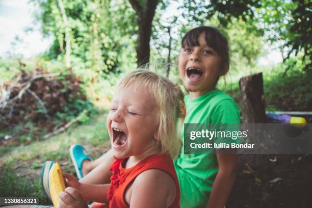 blond happy smiling little girl excited laugh hands in mouth - family trip in laws stock pictures, royalty-free photos & images